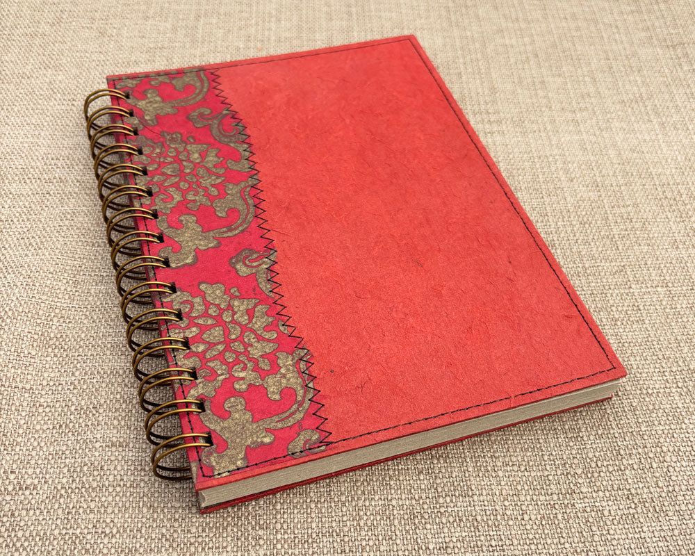 A5 handmade notebook with bold red cover and recycled pages