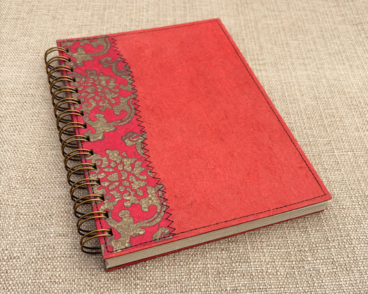 A5 handmade notebook with bold red cover and recycled pages