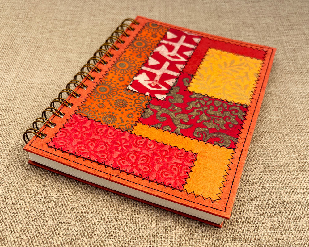 handmade spiral notebook with red and orange patchwork cover