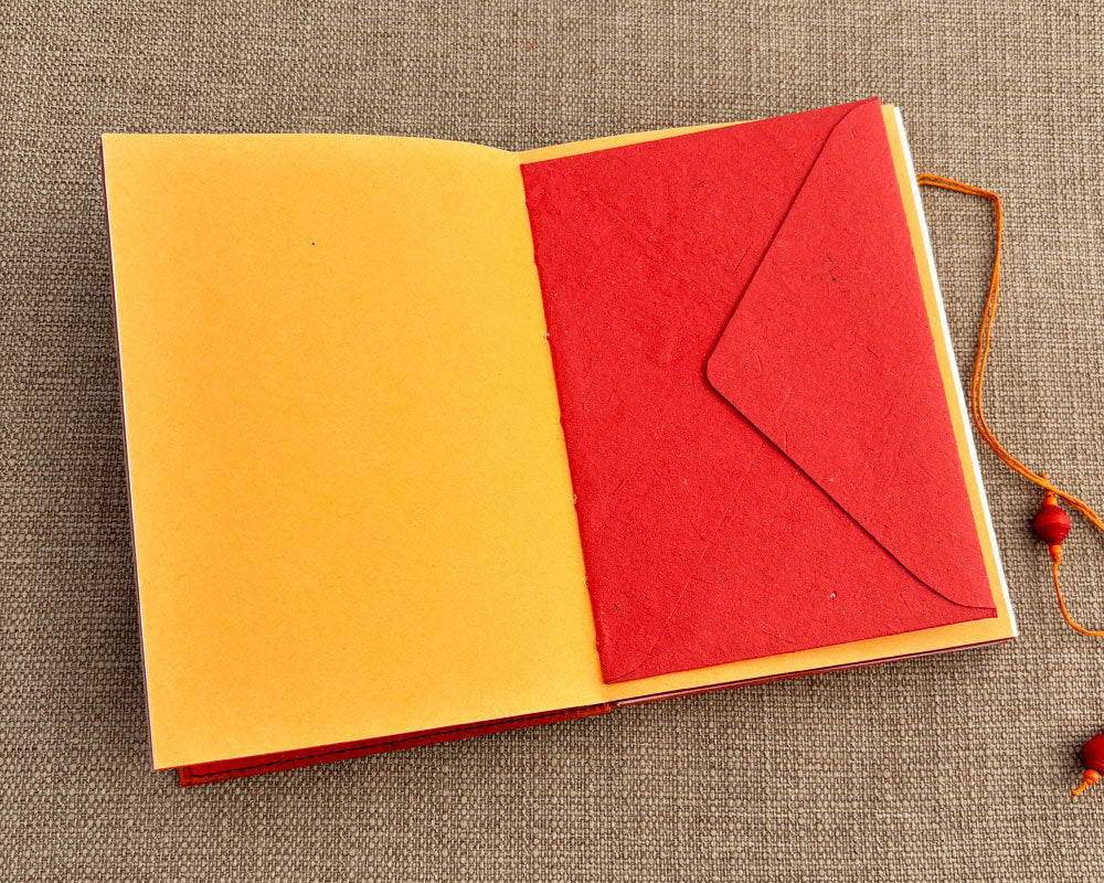 envelope stitched into binding of handmade journal