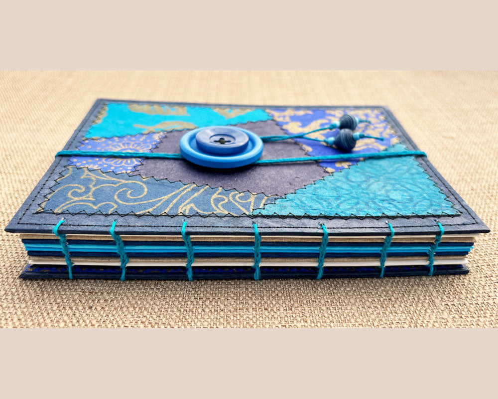 detail of hand stitched spine of blue keepsake journal