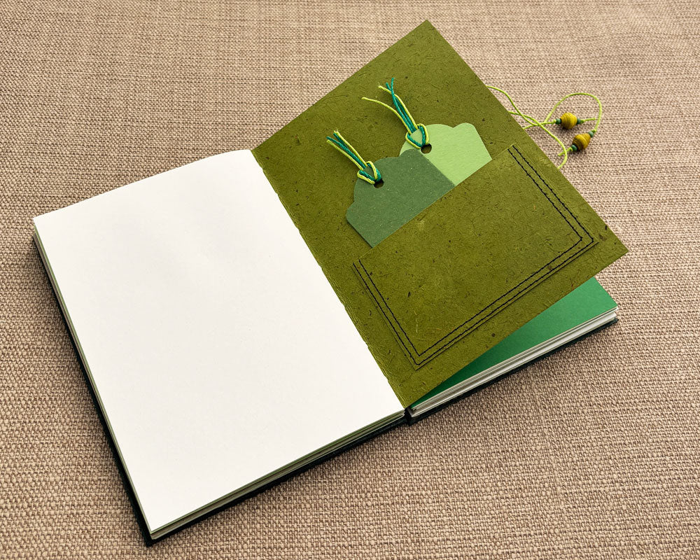 green tage inside pocket of hand bound journal
