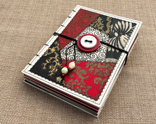 hand bound journal with red black and white patchwork cover