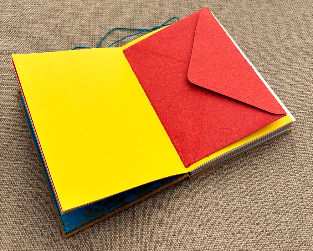 envelope stitched into binding of handmade journal