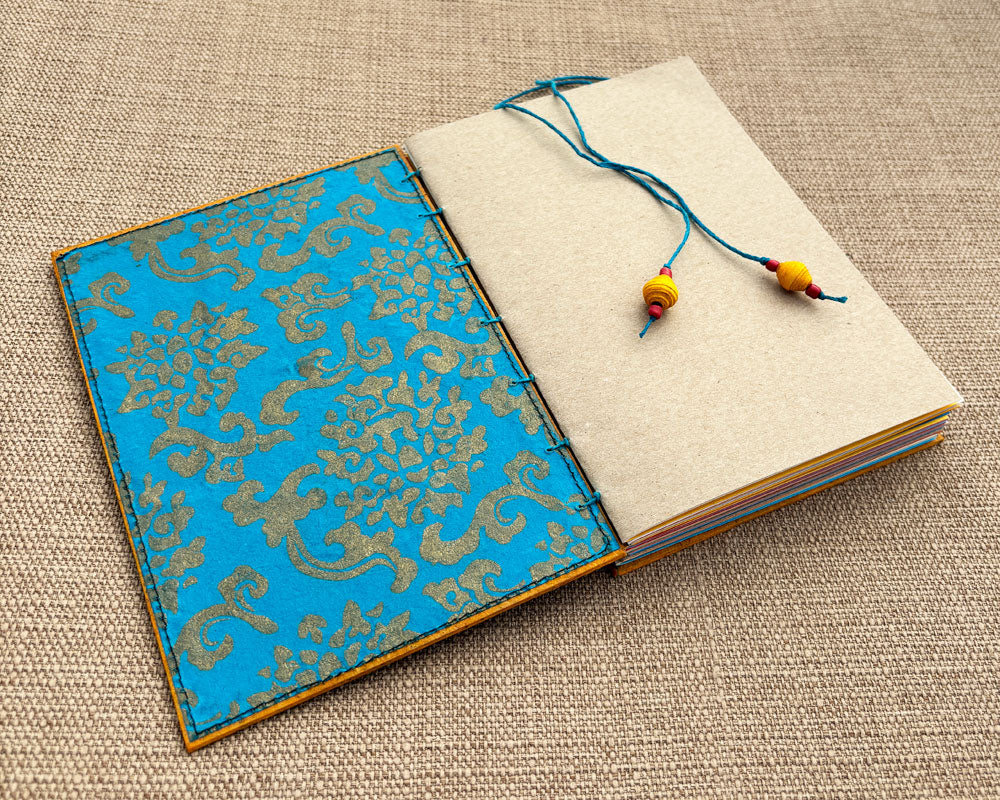 inside cover of hand bound journal featuring turquoise handmade paper