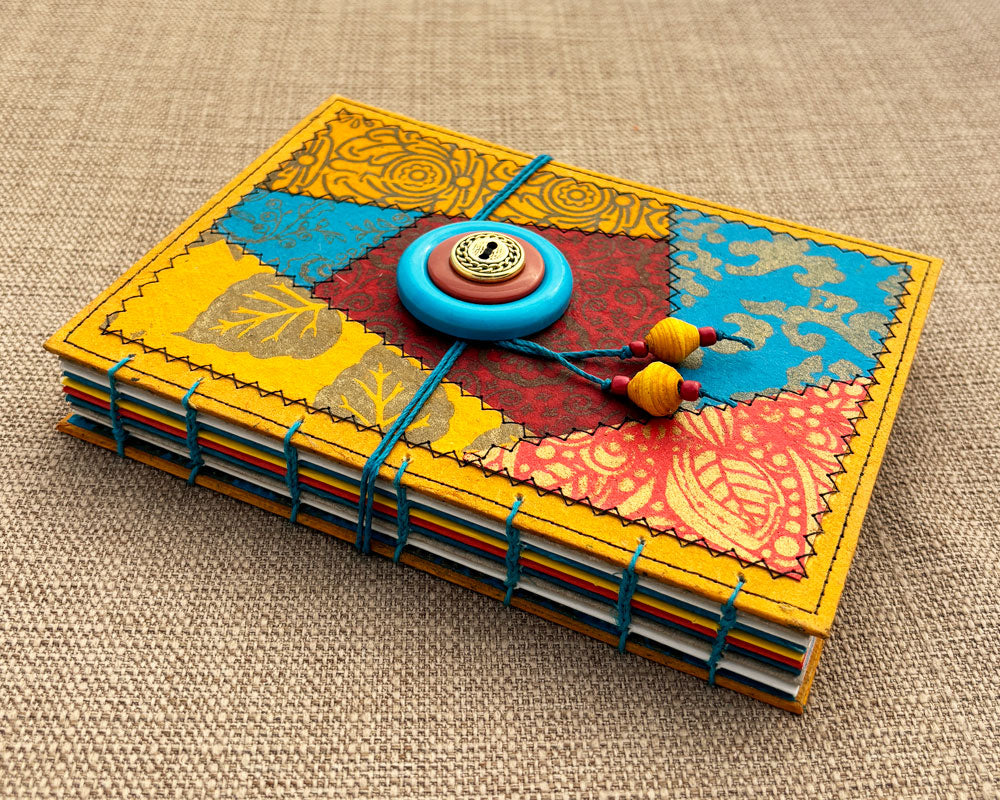 hand bound journal with red, gold and turquoise patchwork cover