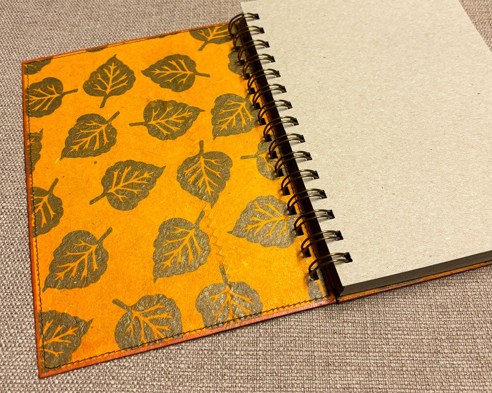 inside leaf-patterned cover of handmade spiral notebook