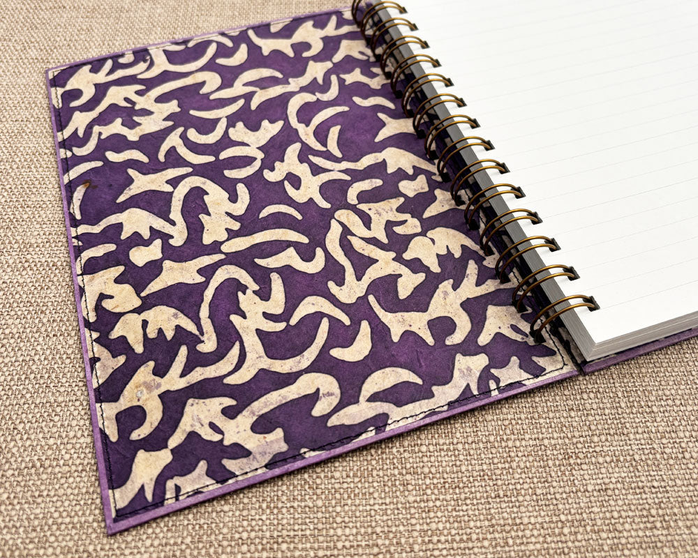 inside cover of handmade spiral notebook showing purple wax paper design