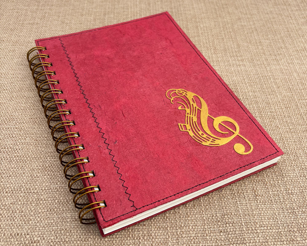 handmade music notebook with red cover and gold treble clef feature